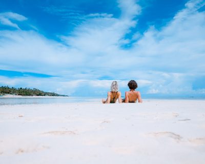 Two people relaxing on a beach